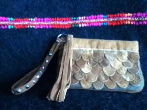 Moose and Caribou Hide Clutch with studded wrist strap and tassel.
